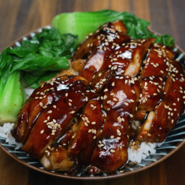 Teriyaki chicken rice bowl with steamed bok choy and sesame seeds