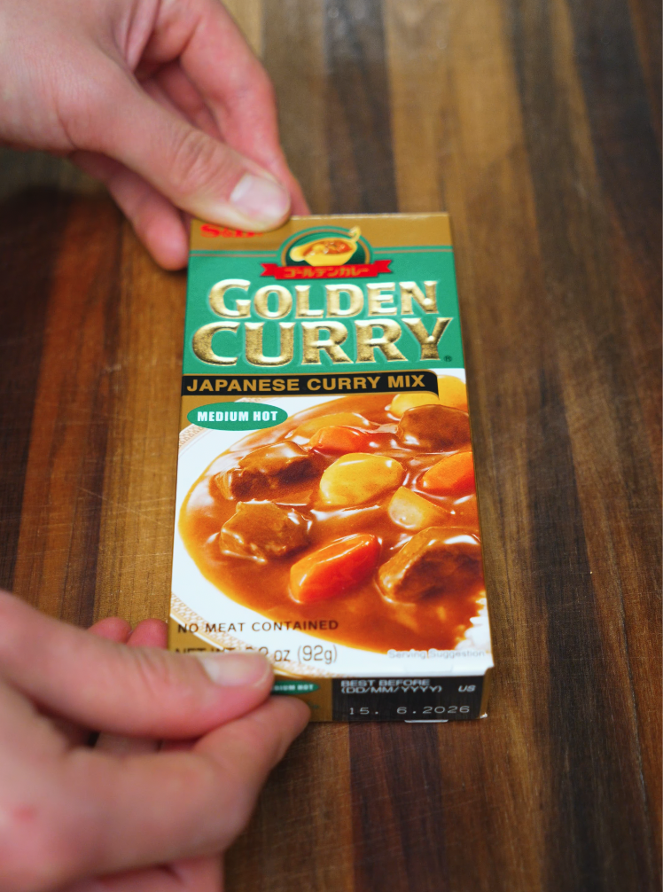 Box of Golden Curry Japanese Curry Mix on wooden table – commonly used base for easy homemade chicken katsu curry.
