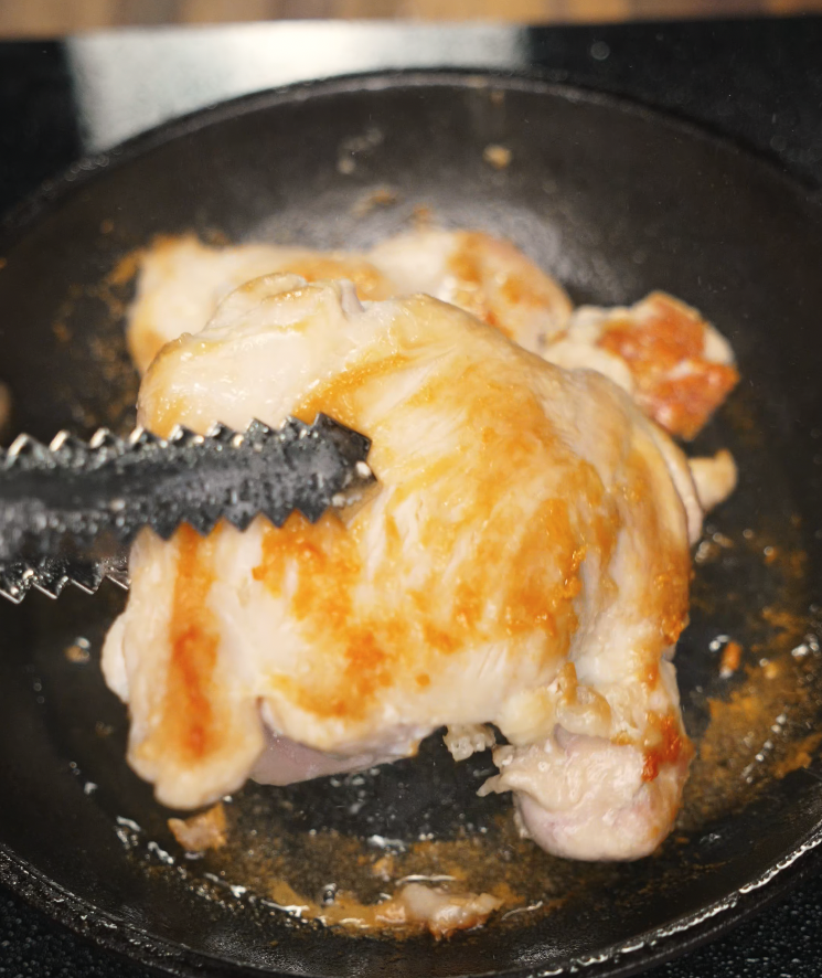 Honey Garlic Chicken, which has been seasoned well with salt on both sides being seared on high heat in oil to prepare it to be dipped in honey garlic sauce.