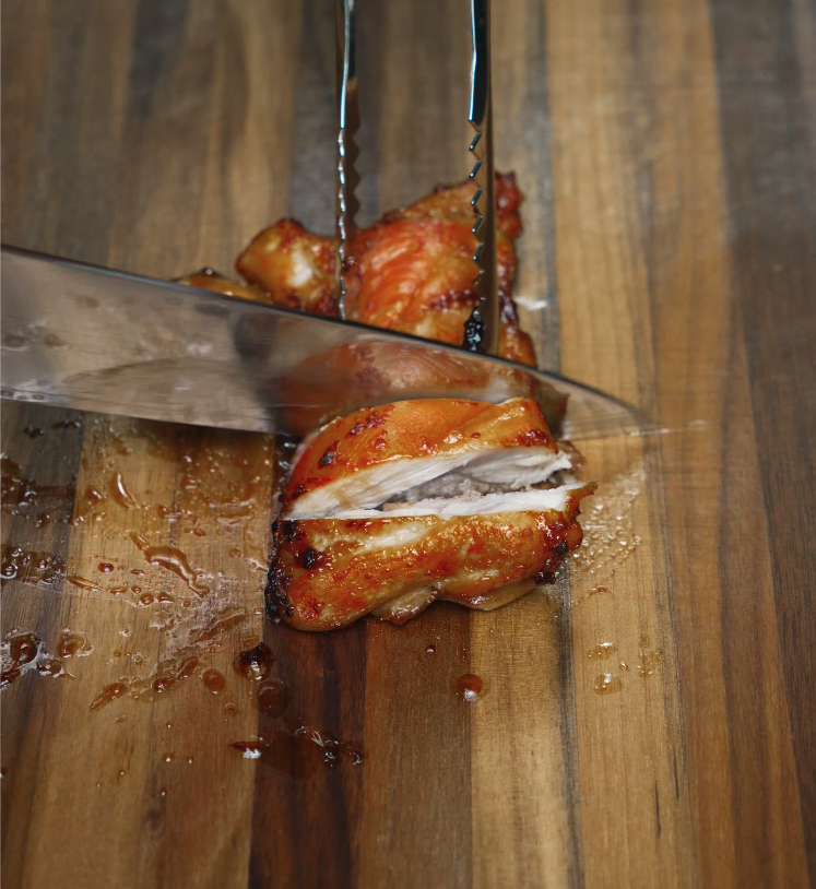 Juicy chicken bulgogi thigh sliced on a cutting board — tender Korean marinated chicken perfect for rice bowls.