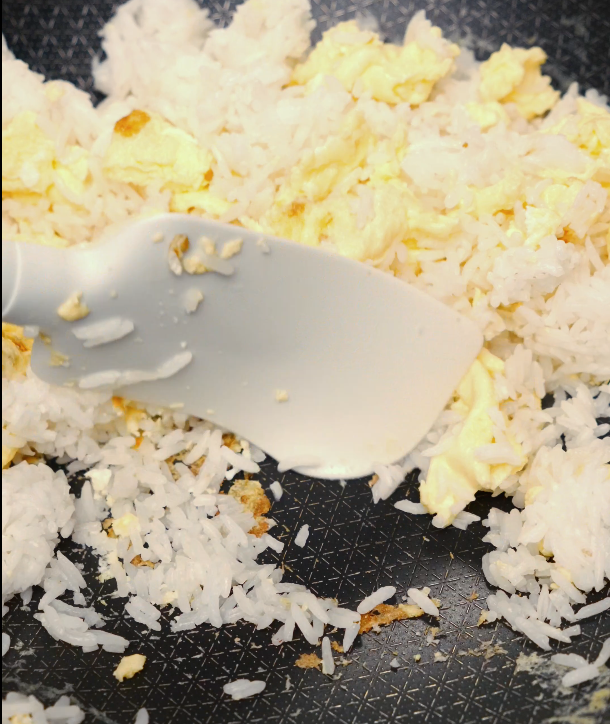 fried rice with scrambled eggs cooking in nonstick pan – quick weeknight dinner