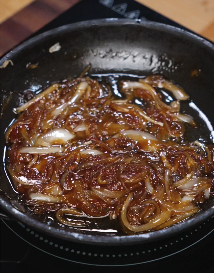 Sliced onions cooked with soy sauce, sesame oil, and sugar until jammy and golden, creating the sweet-savory topping for the Asian Smash Burger.