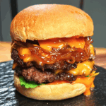 Stacking caramelized onions, cheesy patties, and spicy mayo inside toasted burger buns, bringing together all the rich layers of the Asian Smash Burger.