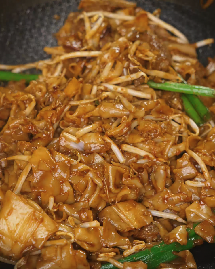 Tossing crunchy bean sprouts into the wok to finish off the Beef Chow Fun, adding a crisp bite and freshness to contrast the chewy noodles and seared beef.