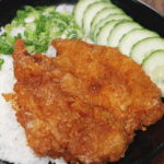 Crispy Taiwanese fried chicken served over steamed white rice with chopped scallions and sliced cucumber.