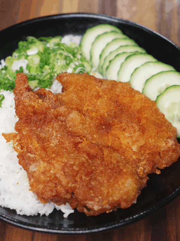 Crispy Taiwanese fried chicken served over steamed white rice with chopped scallions and sliced cucumber.
