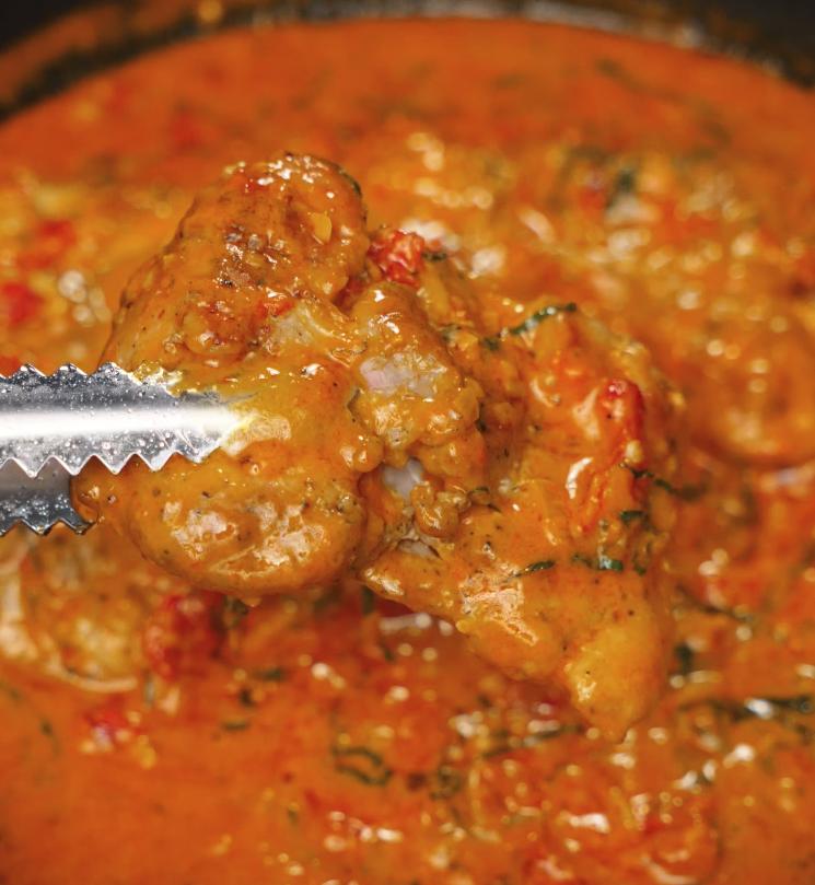 Golden seared chicken is simmering in a rich, creamy tomato sauce packed with herbs and spices for Marry Me Chicken pasta.