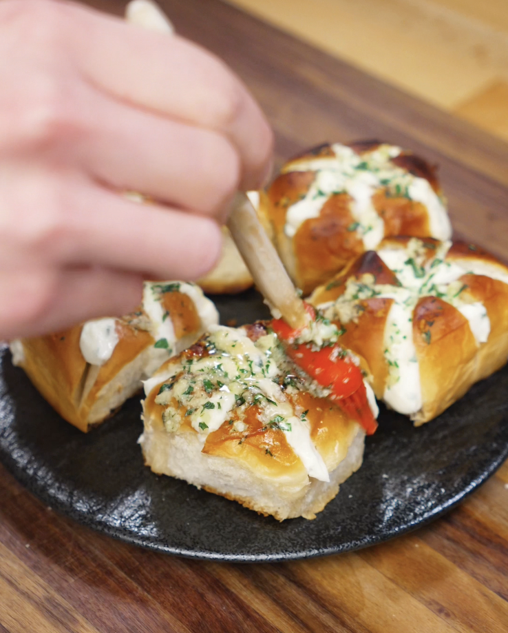 More garlic butter is brushed onto the finished Korean Garlic Cheese Bread for extra flavor and shine before serving.