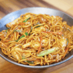 A bowl of glossy Chicken Lo Mein packed with vegetables, chicken strips, and perfectly sauced noodles.