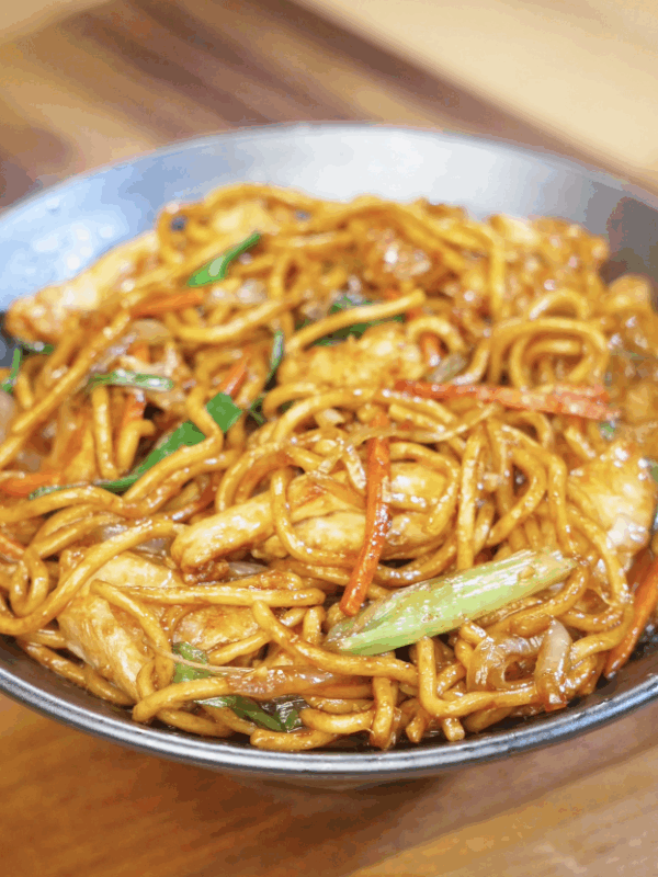 A bowl of glossy Chicken Lo Mein packed with vegetables, chicken strips, and perfectly sauced noodles.