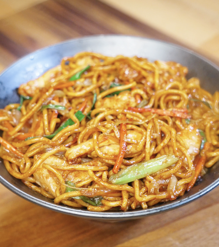 A bowl of glossy Chicken Lo Mein packed with vegetables, chicken strips, and perfectly sauced noodles.