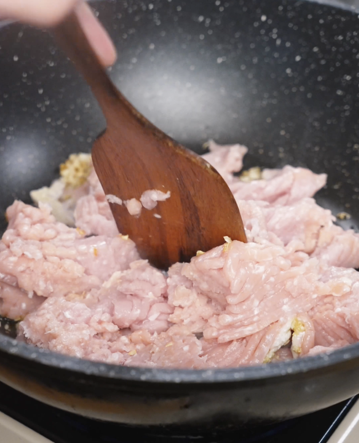 Ground chicken being saut&eacute;ed in a nonstick pan over medium heat as the base for Spicy Peanut Chicken before adding the peanut gochujang sauce.