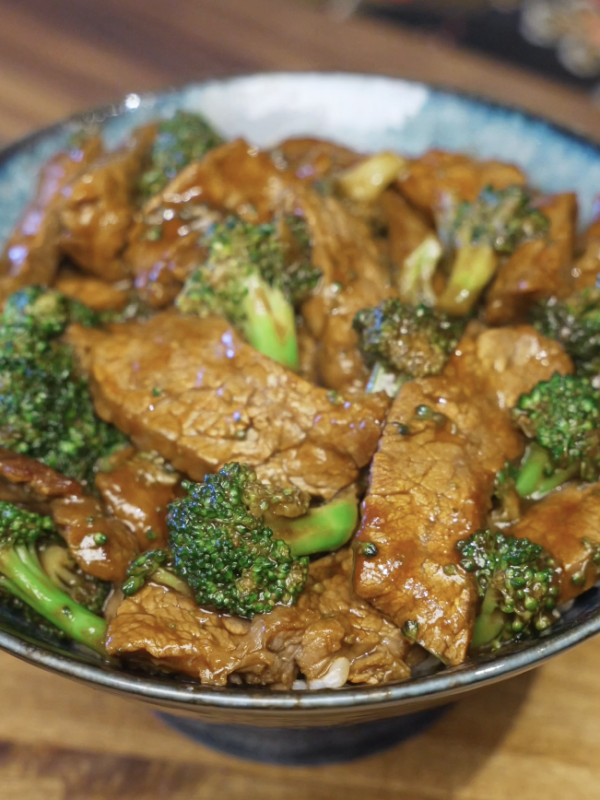 Finished beef and broccoli coated in a glossy brown sauce, with tender beef slices and crisp broccoli florets.