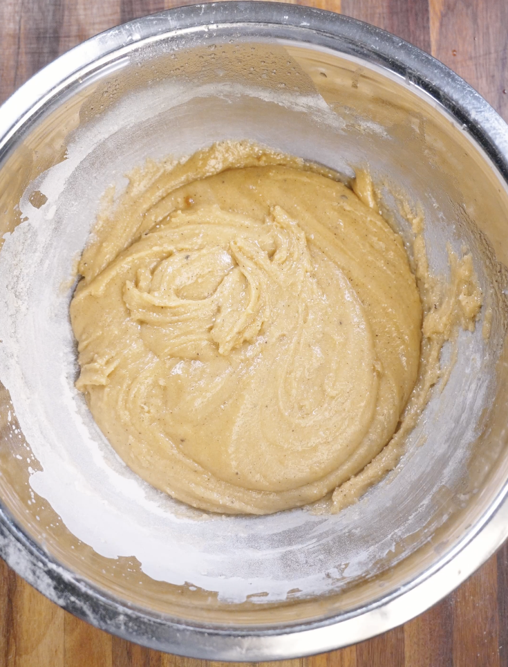 All-purpose flour, baking soda, and salt added to the cookie dough and gently folded in to prevent overmixing.