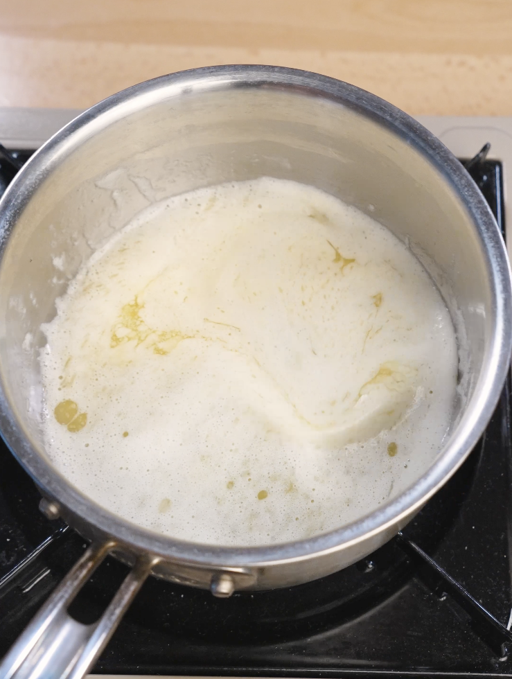 Unsalted butter gently heated in a saucepan until fully melted and warm, forming the base for a rich fudgy Oreo brownie batter.