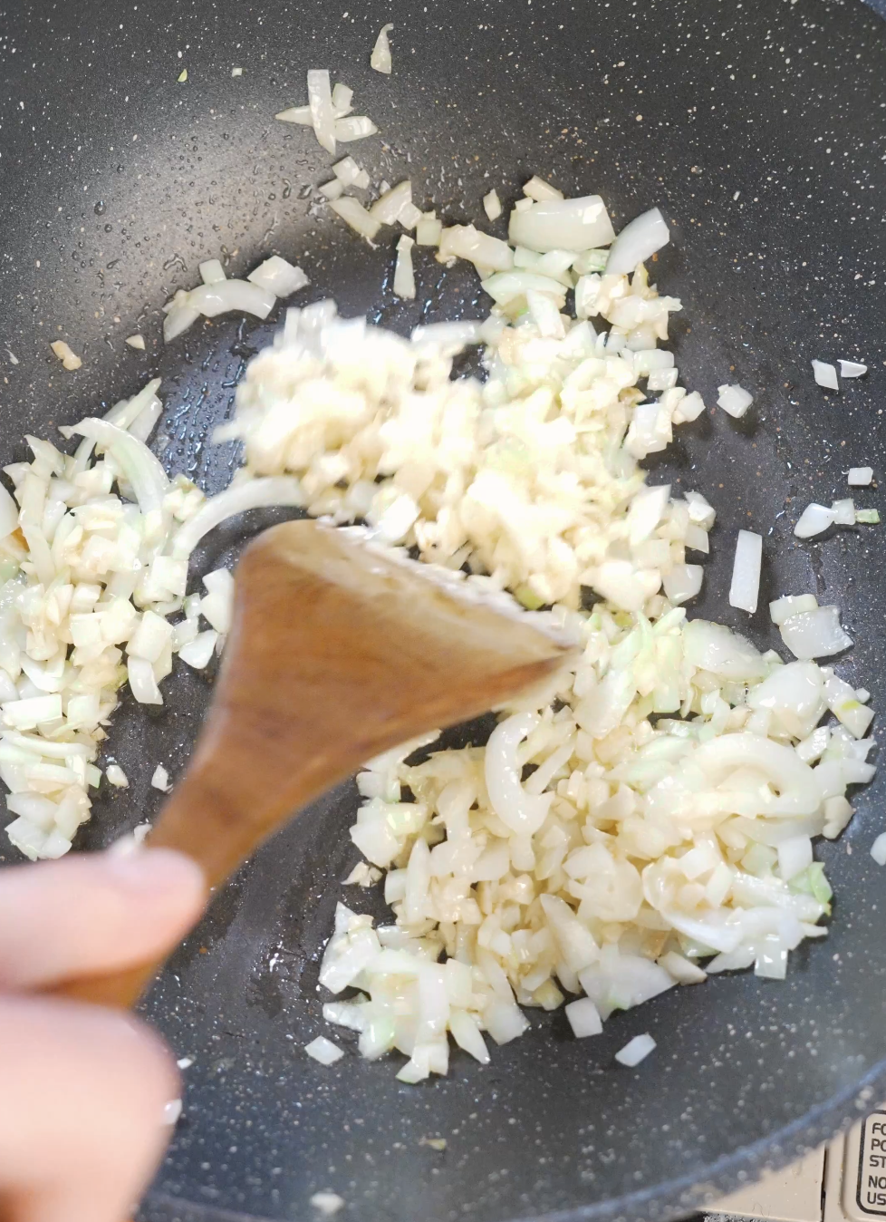 Finely diced onion and minced garlic saut&eacute;ed in olive oil in a skillet until soft and fragrant to build the base of vodka pasta sauce.
