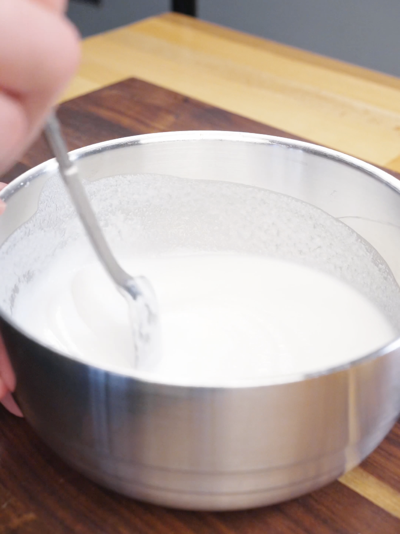 Bowl of rice flour and potato starch batter being mixed with water until smooth for the Honey Butter Chicken Tenders Recipe.