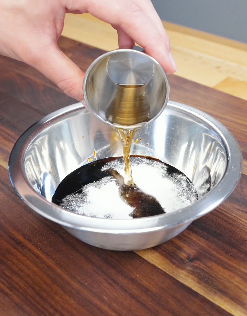 Soy sauce, sugar, and Shaoxing wine being poured into a bowl to create the savory chow mein sauce for the Beef Chow Mein Recipe.
