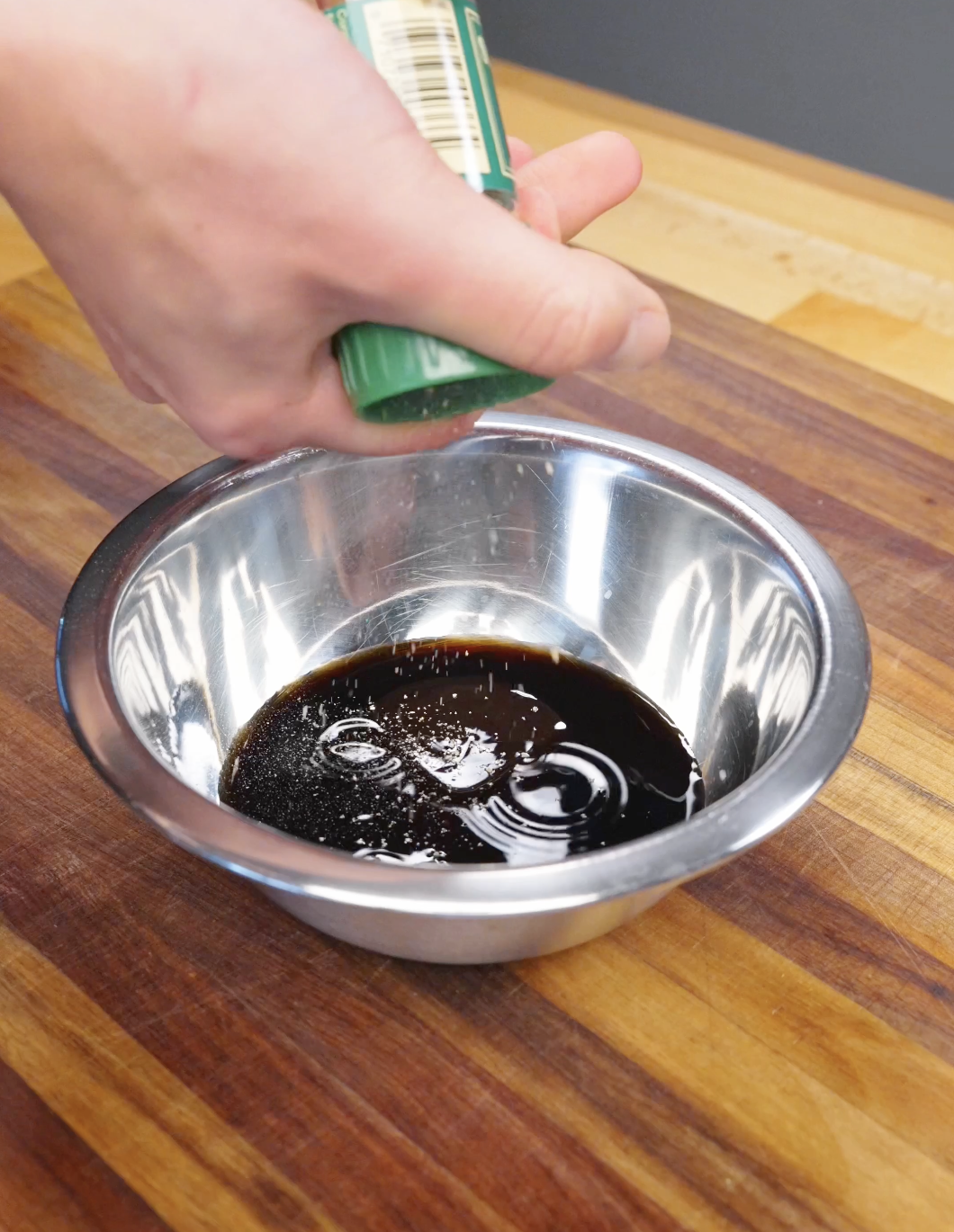 Soy sauce mixture being prepared in a bowl for garlic bacon fried rice.