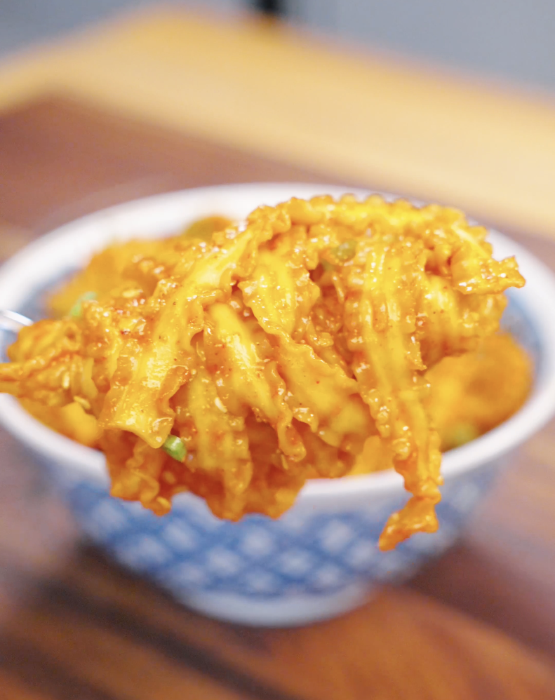 Forkful of creamy Gochujang Butter Noodles lifted above a bowl, coated in a rich spicy sauce made with gochujang, butter, garlic, and soy sauce. These quick Korean-inspired noodles are packed with flavor and perfect for an easy weeknight meal.