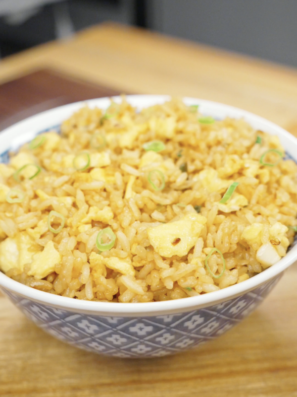 Bowl of Egg Fried Rice topped with fresh scallions and made with fluffy scrambled eggs, garlic, and seasoned day-old rice. This easy one-pan rice dish is perfect for weeknight dinners and meal prep.