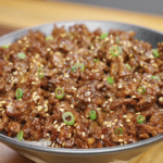 Bowl of Sticky Ground Beef Recipe served over steamed rice and garnished with sesame seeds and scallions for an easy high-protein dinner.