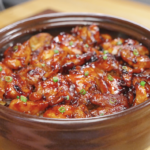 Finished bowl of Sticky Sweet Chicken coated in a rich caramelized soy honey glaze and garnished with fresh scallions. This easy Sticky Sweet Chicken Recipe is perfect for serving over rice for a quick and flavorful weeknight dinner.