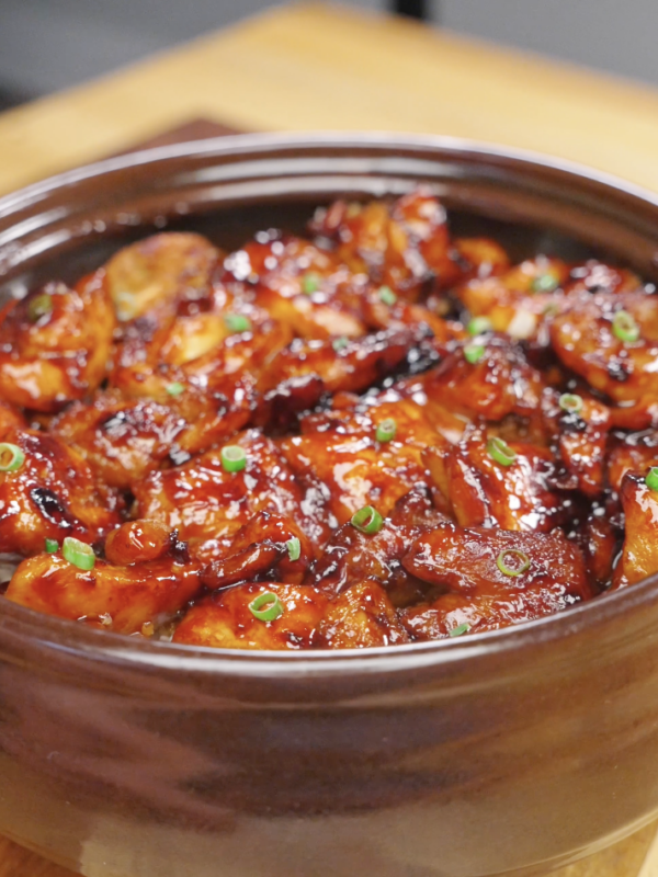 Finished bowl of Sticky Sweet Chicken coated in a rich caramelized soy honey glaze and garnished with fresh scallions. This easy Sticky Sweet Chicken Recipe is perfect for serving over rice for a quick and flavorful weeknight dinner.