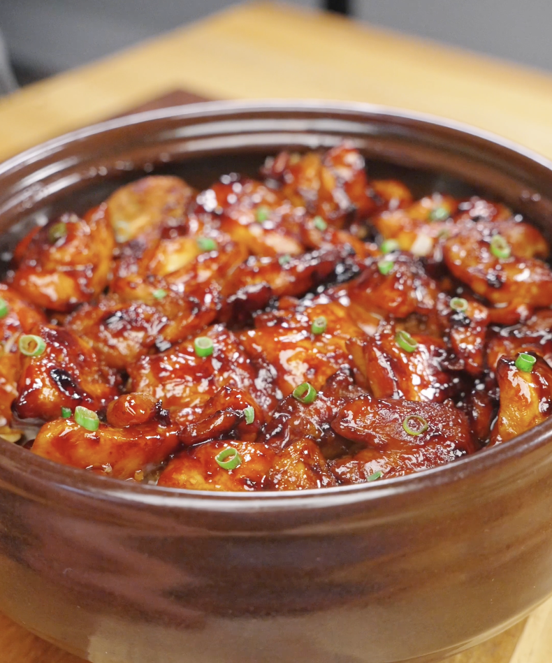 Finished bowl of Sticky Sweet Chicken coated in a rich caramelized soy honey glaze and garnished with fresh scallions. This easy Sticky Sweet Chicken Recipe is perfect for serving over rice for a quick and flavorful weeknight dinner.