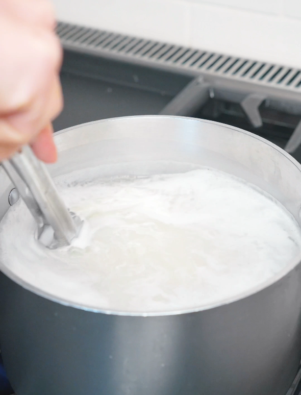 Fresh noodles cooking in a pot of boiling water for the Mongolian Beef Noodles Recipe.