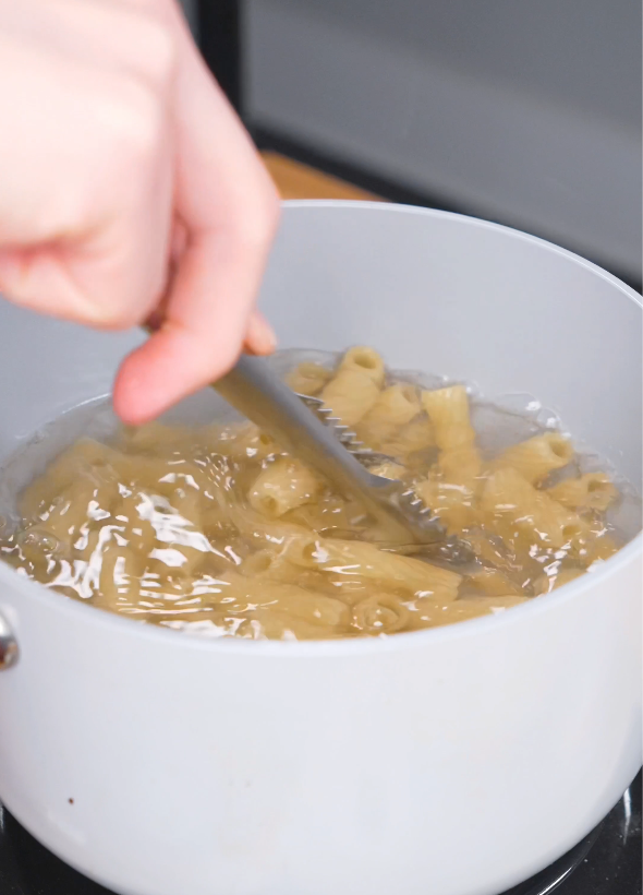 Rigatoni pasta boiling in a pot of salted water until just before al dente for this Gochujang Vodka Pasta Recipe.