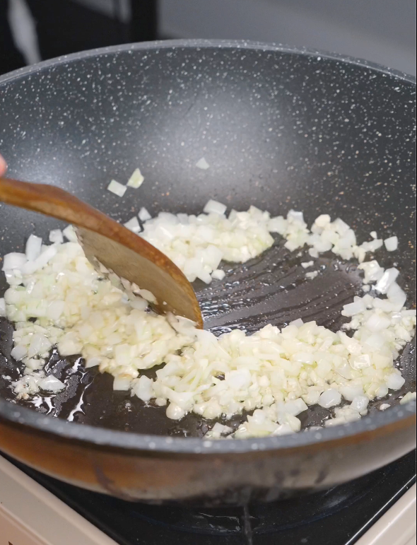 Finely diced onion and minced garlic sautéing in oil until softened to build the flavor base for this Gochujang Vodka Pasta Recipe.