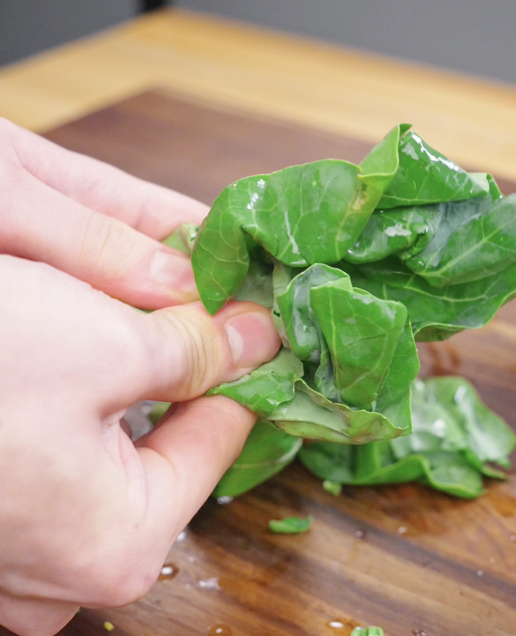 Fresh Chinese broccoli being cut into smaller pieces before being added to this Pad See Ew Recipe.