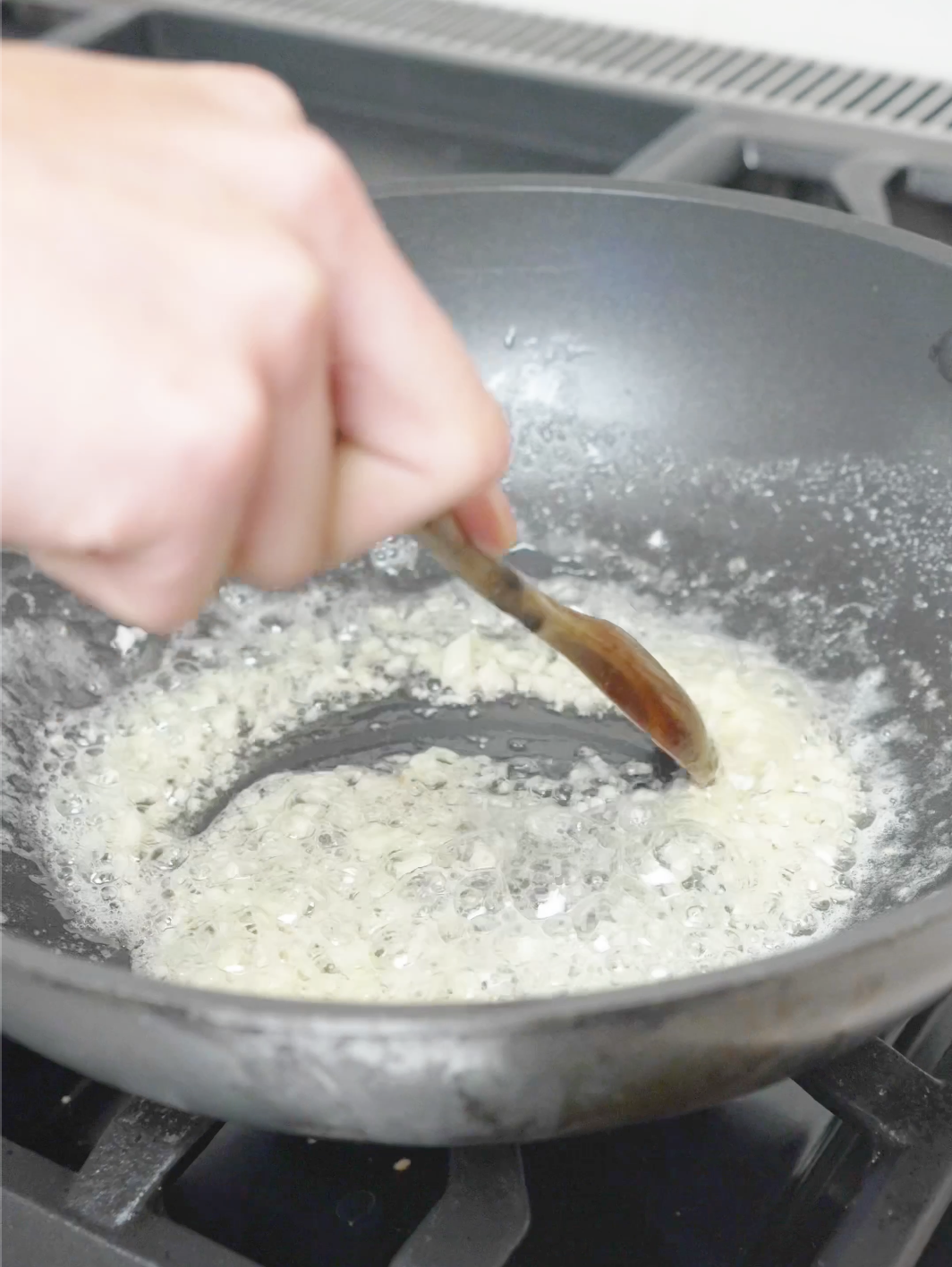 Minced garlic cooking in melted butter in a pan for the Creamy Garlic Butter Noodles Recipe.