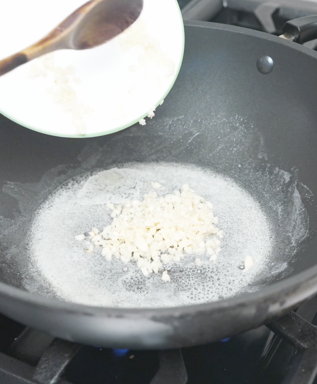 Minced garlic cooking in melted butter to build the base of Garlic Butter Fried Rice Recipe.
