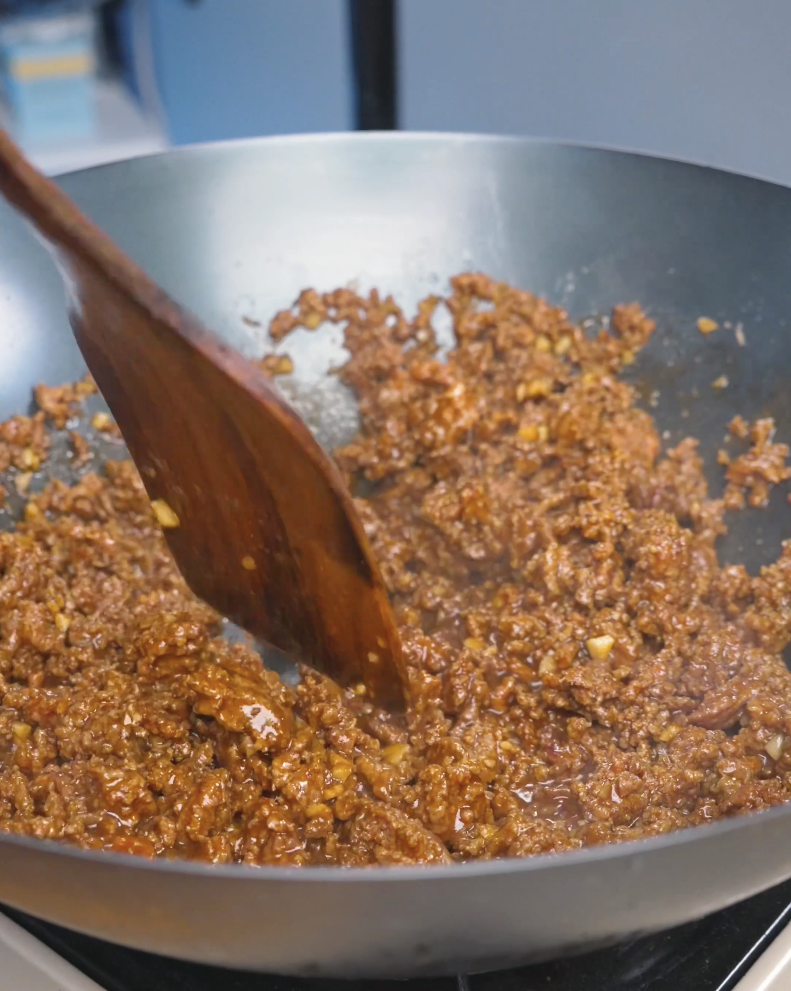 Ground beef simmering and thickening in glossy garlic sauce while cooking Garlic Ground Beef Recipe.