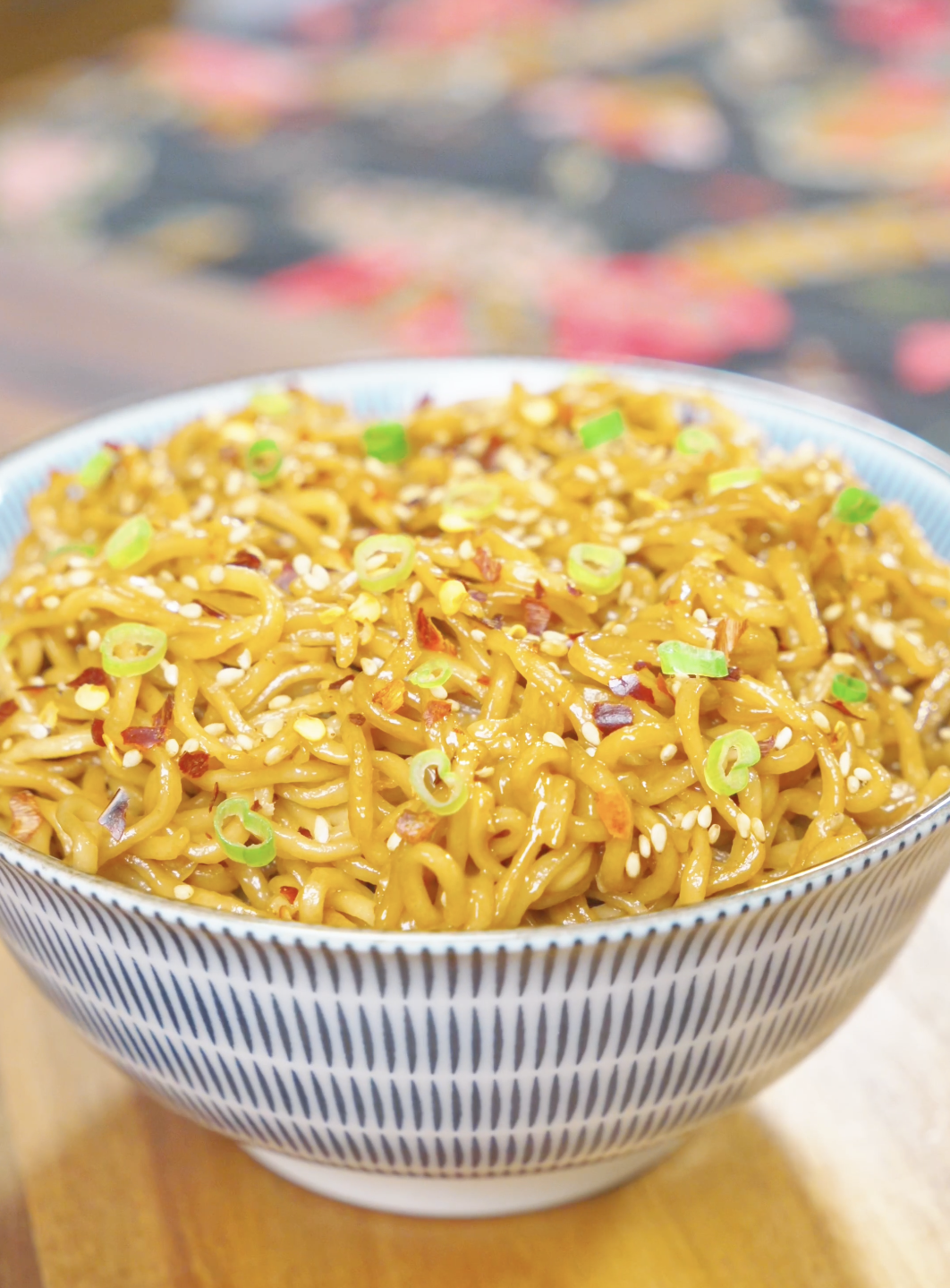 Creamy Garlic Butter Noodles Recipe served in a bowl with a rich garlic butter sauce, sesame seeds, scallions, and red pepper flakes.