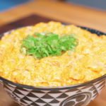 Finished Creamy Salmon Poke Recipe served in a patterned bowl and topped with fresh scallions.