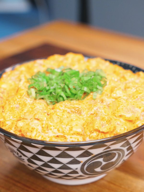 Finished Creamy Salmon Poke Recipe served in a patterned bowl and topped with fresh scallions.