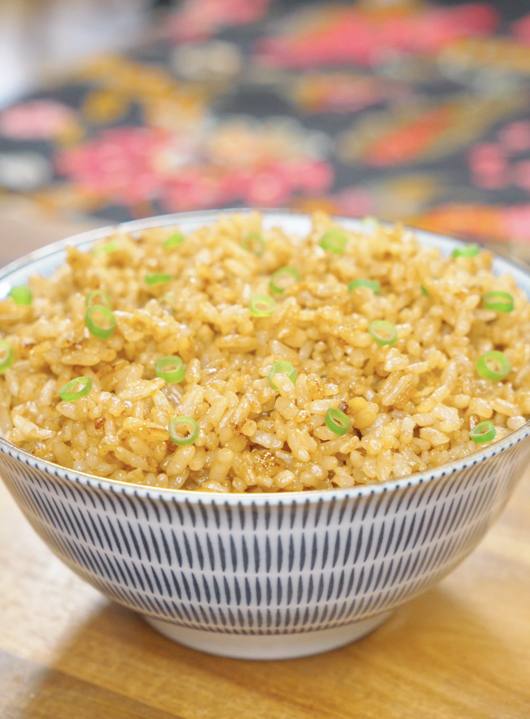 A bowl of Garlic Butter Fried Rice Recipe garnished with fresh scallions and ready to serve.