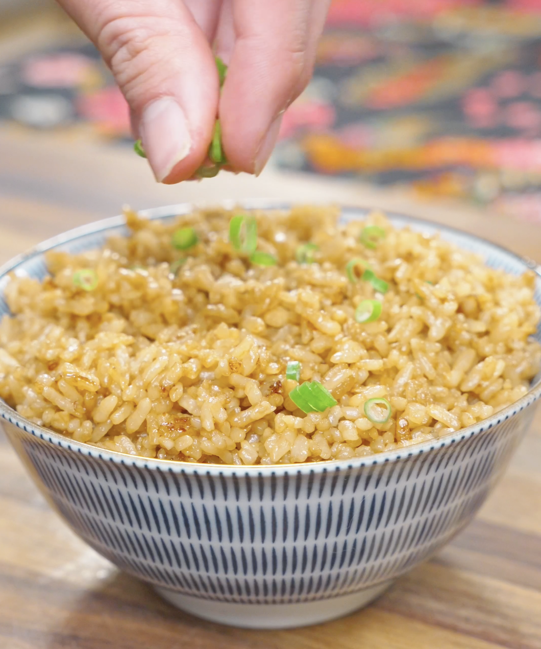 Garlic Butter Fried Rice Recipe being finished with fresh scallions before serving.