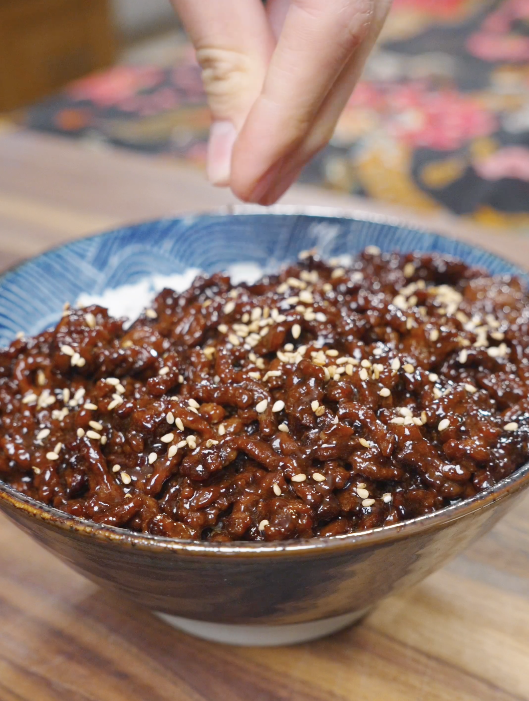 Sticky Sweet Ground Beef Recipe being finished with sesame seeds before serving.