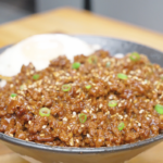 Finished Garlic Butter Ground Beef Recipe over rice with sesame seeds, scallions, and a fried egg.