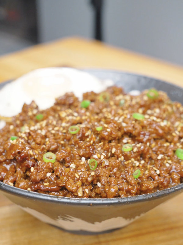 Finished Garlic Butter Ground Beef Recipe over rice with sesame seeds, scallions, and a fried egg.