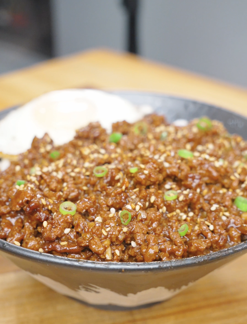 Finished Garlic Butter Ground Beef Recipe over rice with sesame seeds, scallions, and a fried egg.