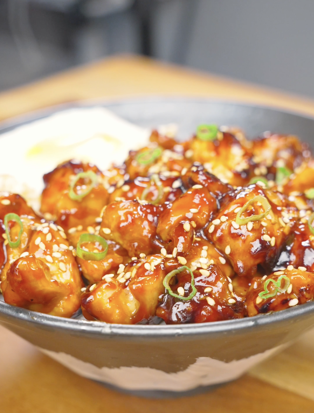 Finished Honey BBQ Chicken Recipe over rice with sesame seeds, scallions, and a fried egg.
