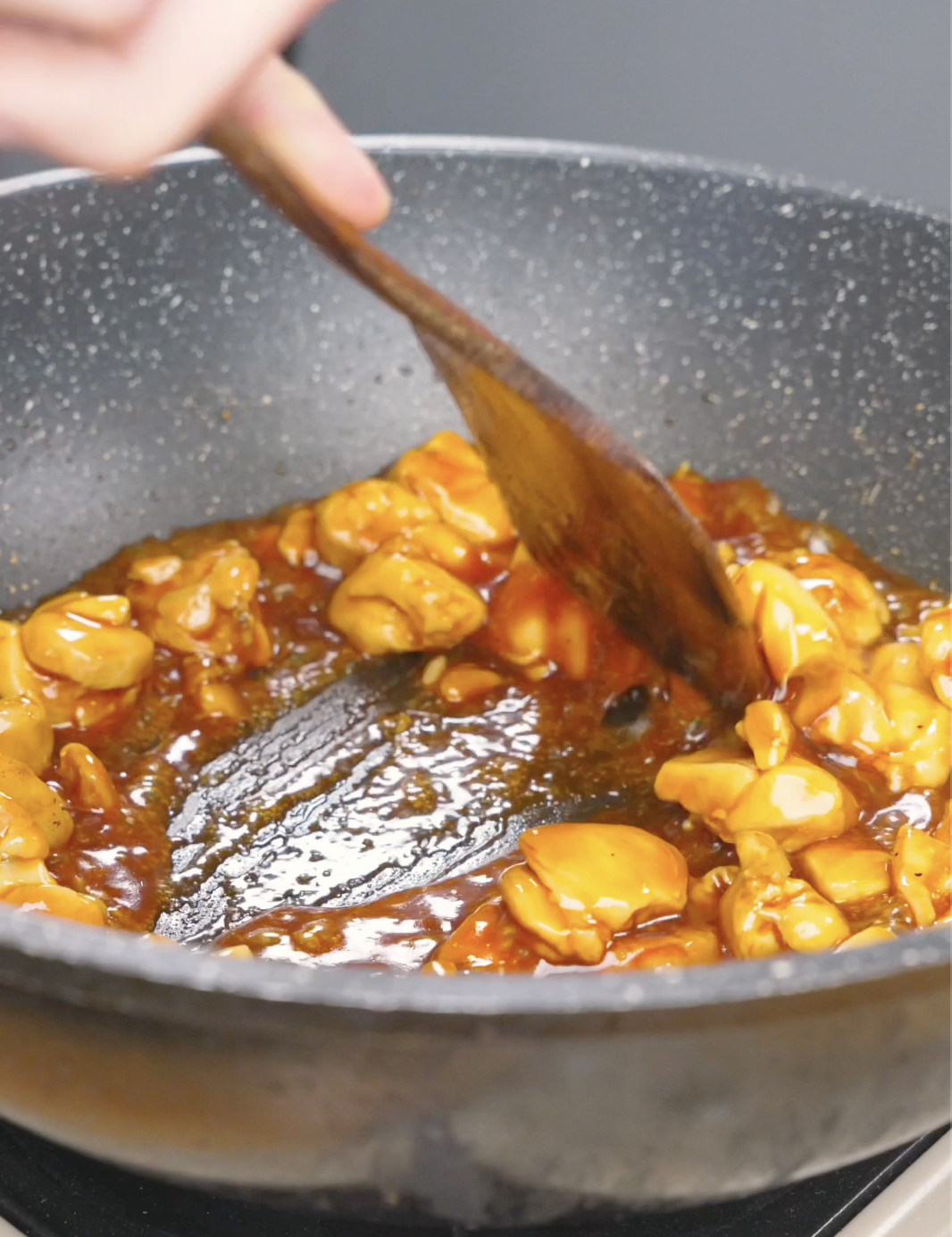 Chicken simmering and thickening in a glossy honey barbecue sauce for Honey BBQ Chicken Recipe.