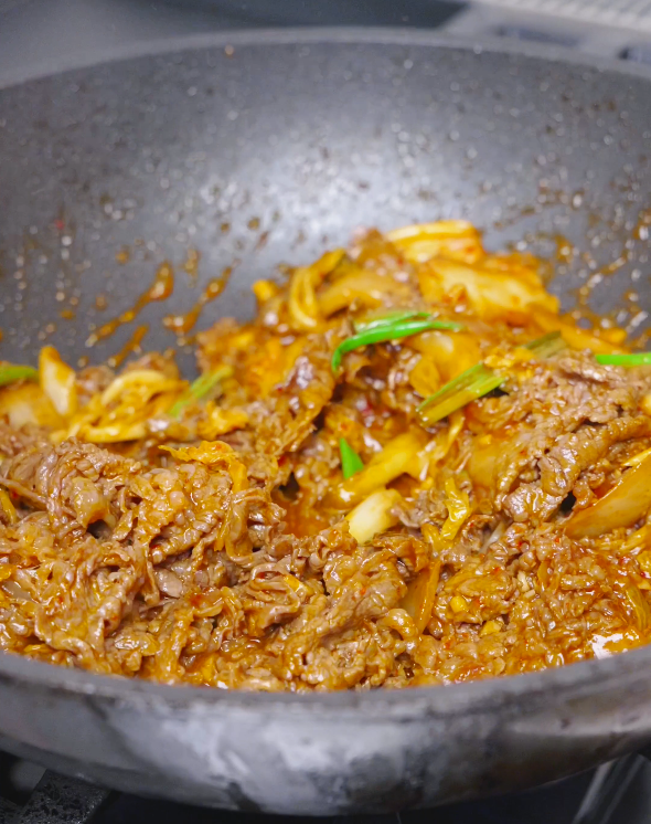 Beef, kimchi, and scallions tossed together in a glossy reduced sauce for Kimchi Beef Stir Fry Recipe.