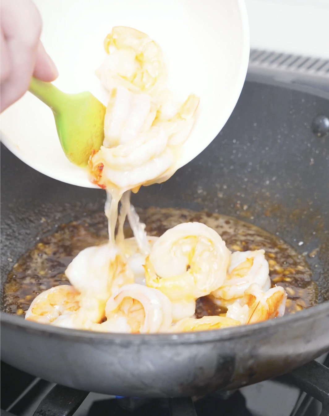 Shrimp being returned to the pan of garlic butter sauce to finish cooking for Garlic Butter Shrimp Recipe.