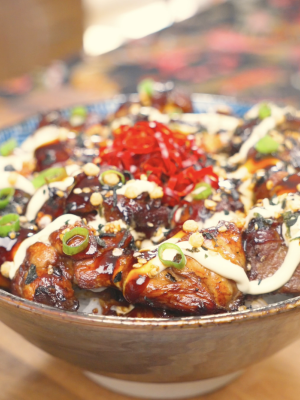 Finished Garlic Teriyaki Chicken Recipe over rice with kewpie mayo, soy glaze, furikake, scallions, and pickled ginger.